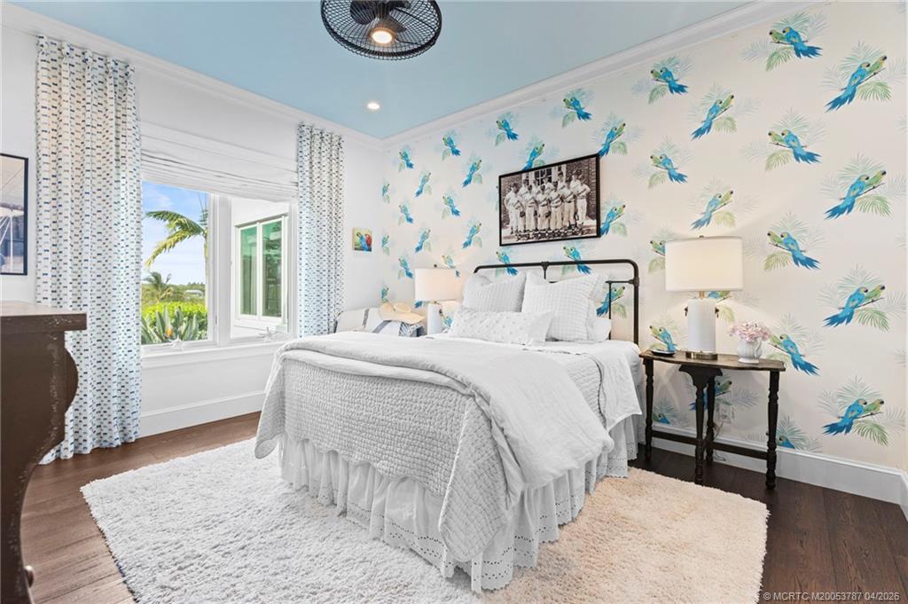 3 Island Road Sewall's Point, FL 34996 - Photo 36 of 59 a bedroom with a bed and a chair