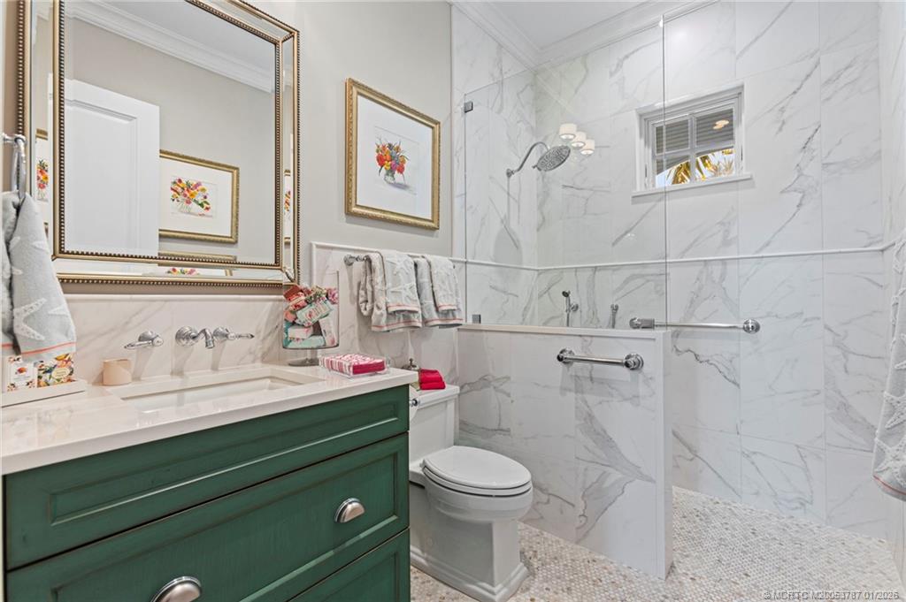 3 Island Road Stuart, FL 34996 - Photo 37 of 58 a bathroom with a sink mirror vanity and toilet