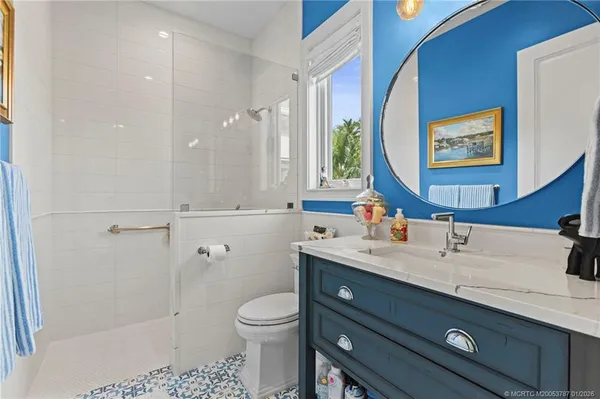 a spacious bathroom with a bathtub sink mirror and toilet
