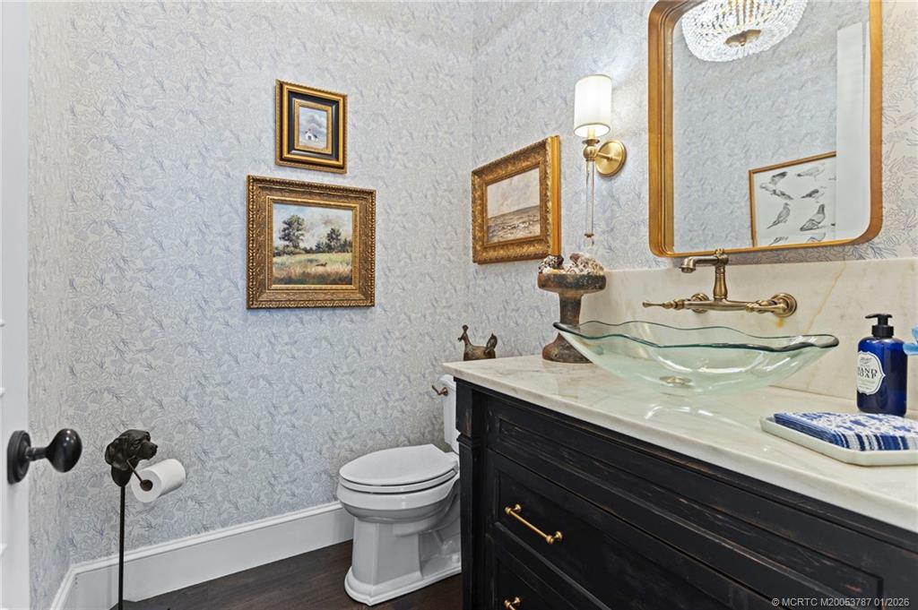 3 Island Road Stuart, FL 34996 - Photo 41 of 58 a bathroom with a granite countertop toilet sink and mirror