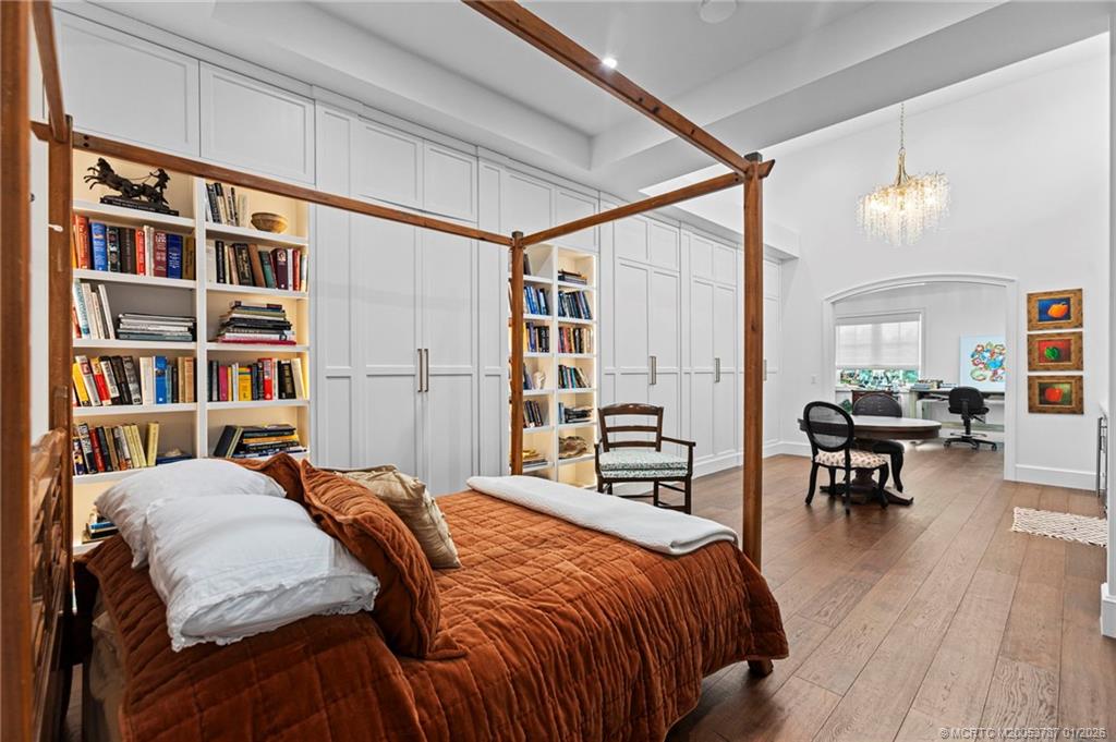 3 Island Road Stuart, FL 34996 - Photo 42 of 58 a bedroom with a bed a table and a book shelf