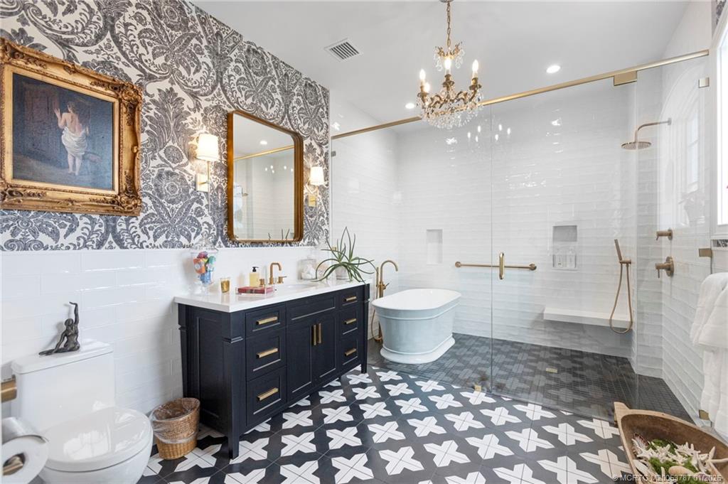 3 Island Road Stuart, FL 34996 - Photo 45 of 58 a spacious bathroom with a bathtub sink mirror and toilet