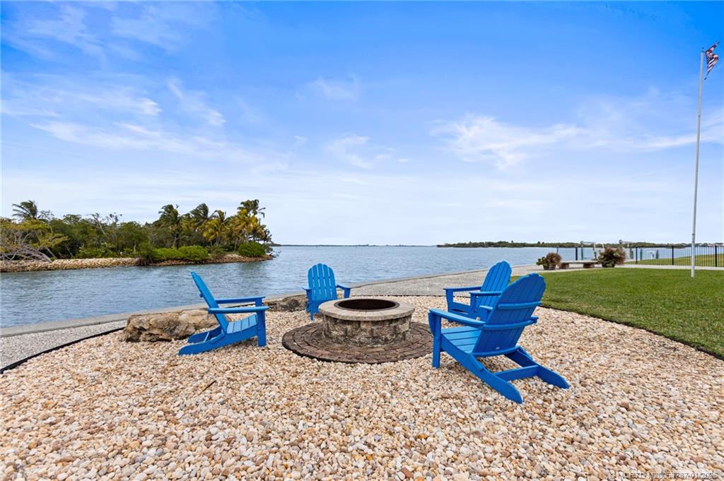 3 Island Road Stuart, FL 34996 - Photo 52 of 58 a backyard view of a lake and outdoor seating