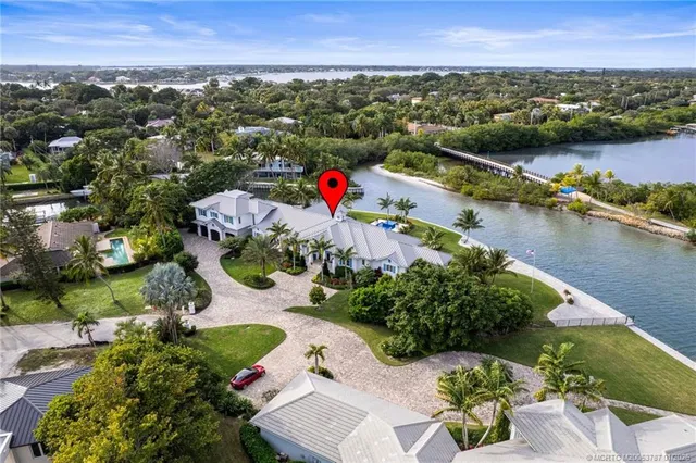 an aerial view of a house a yard swimming pool and outdoor seating