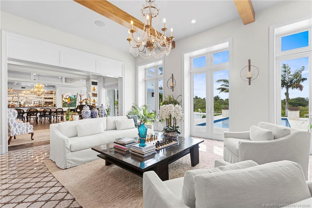 3 Island Road Stuart, FL 34996 - Photo 10 of 58 a living room with furniture and a chandelier