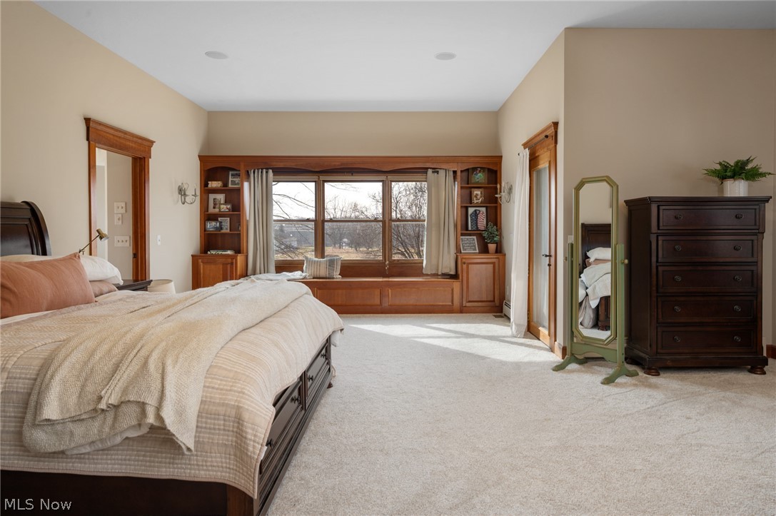 9419 Robinson Road Chardon, OH 44024 - Photo 21 of 46 Primary bedroom with carpet floors, built in window bench, and private access to front porch