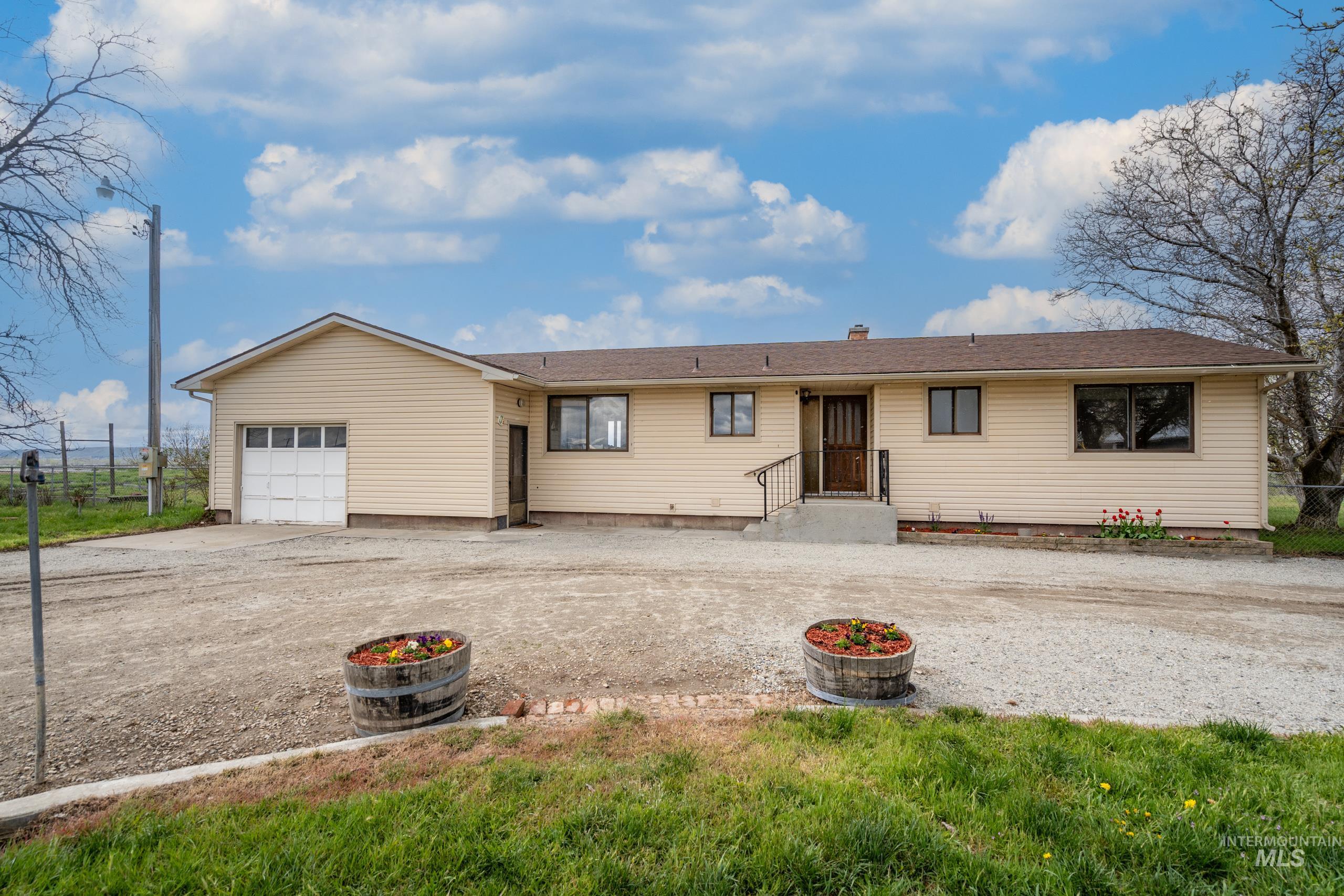 Single story home with a garage, driveway, and a chimney