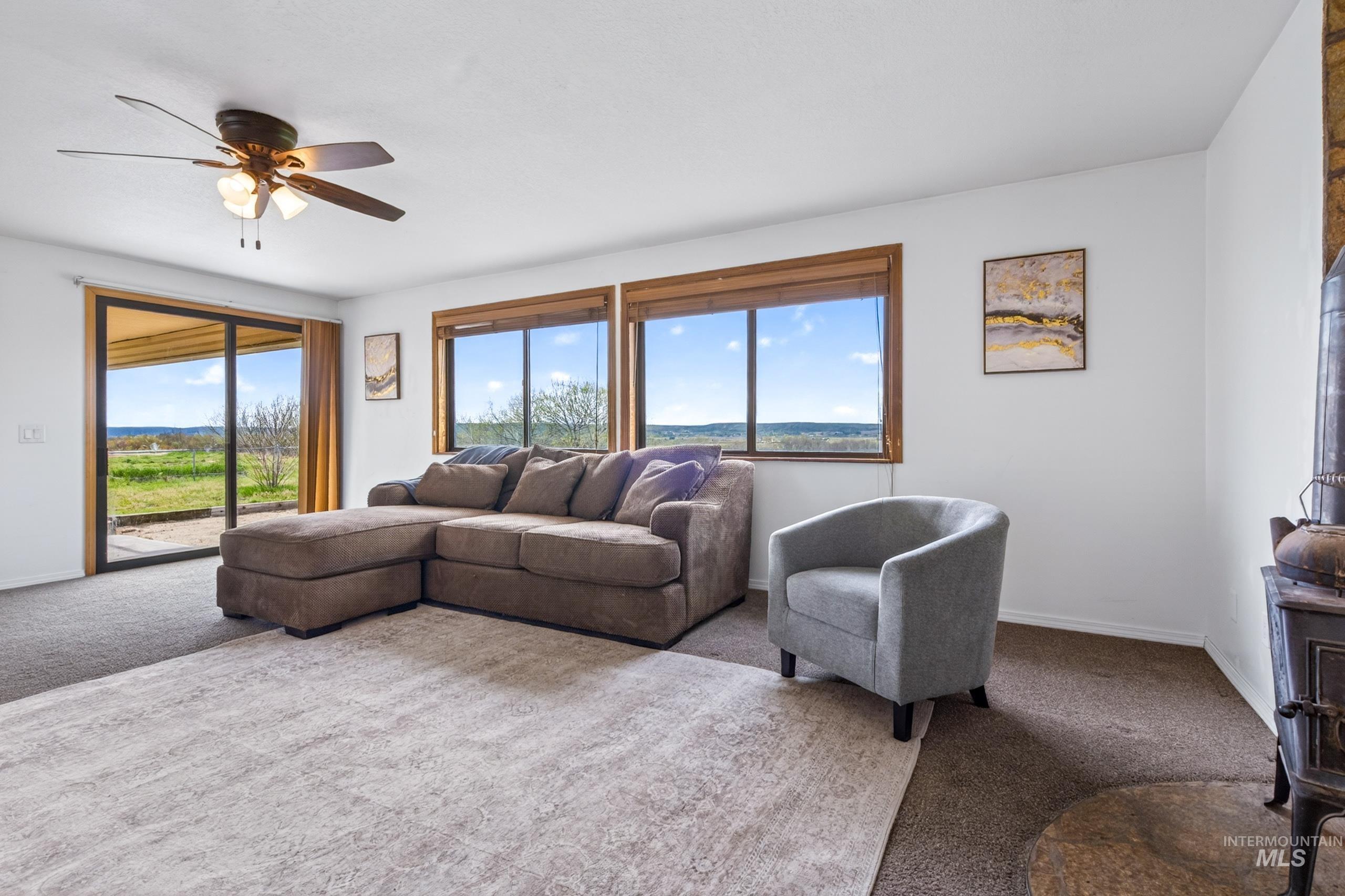8989 Hillview Road Emmett, ID 83617 - Photo 15 of 50 Carpeted living area with ceiling fan and plenty of natural light