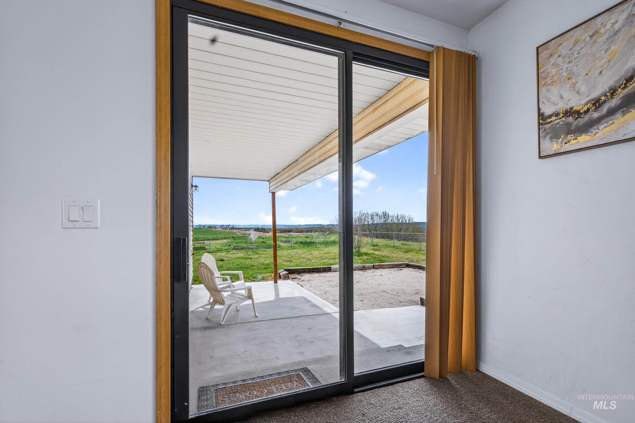 8989 Hillview Road Emmett, ID 83617 - Photo 20 of 50 Doorway to outside featuring carpet and baseboards