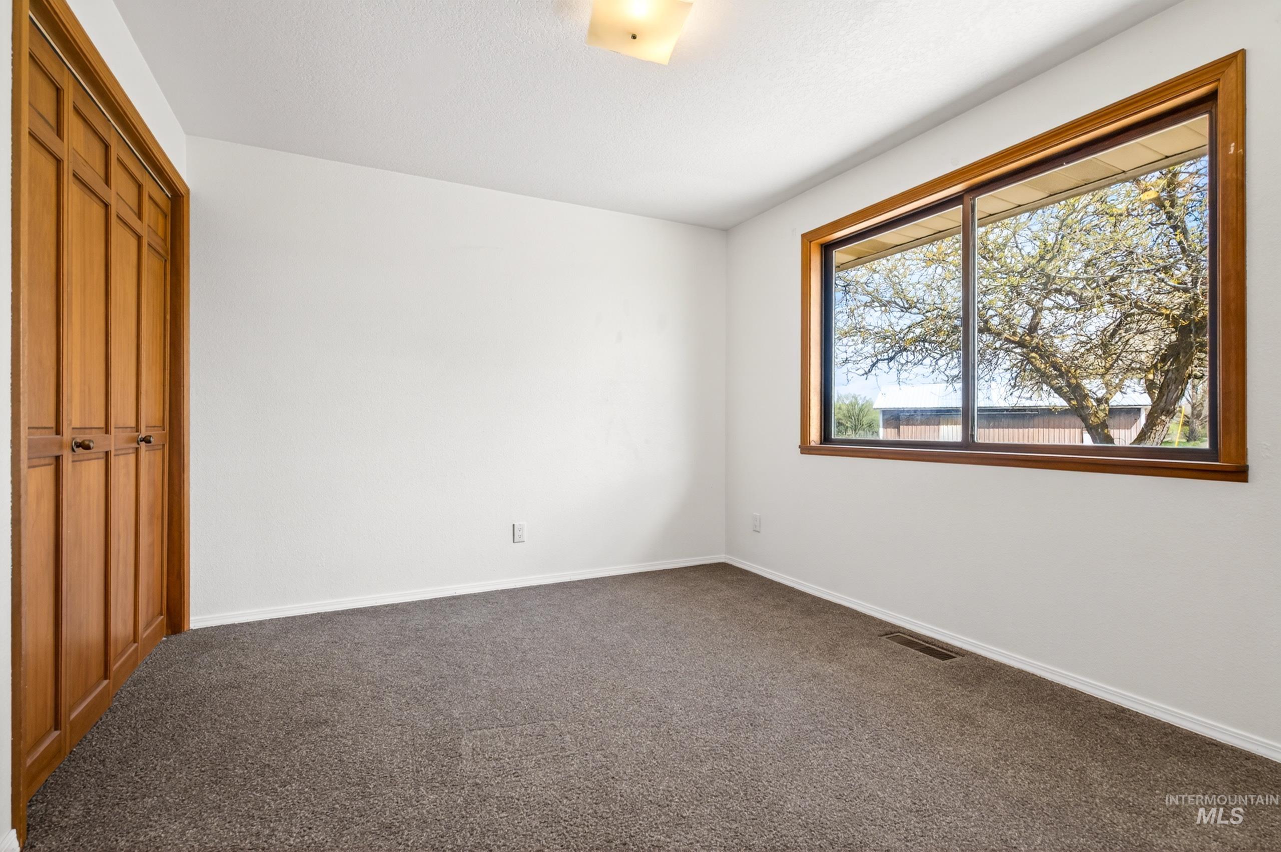 8989 Hillview Road Emmett, ID 83617 - Photo 26 of 50 Unfurnished bedroom featuring a closet and dark colored carpet