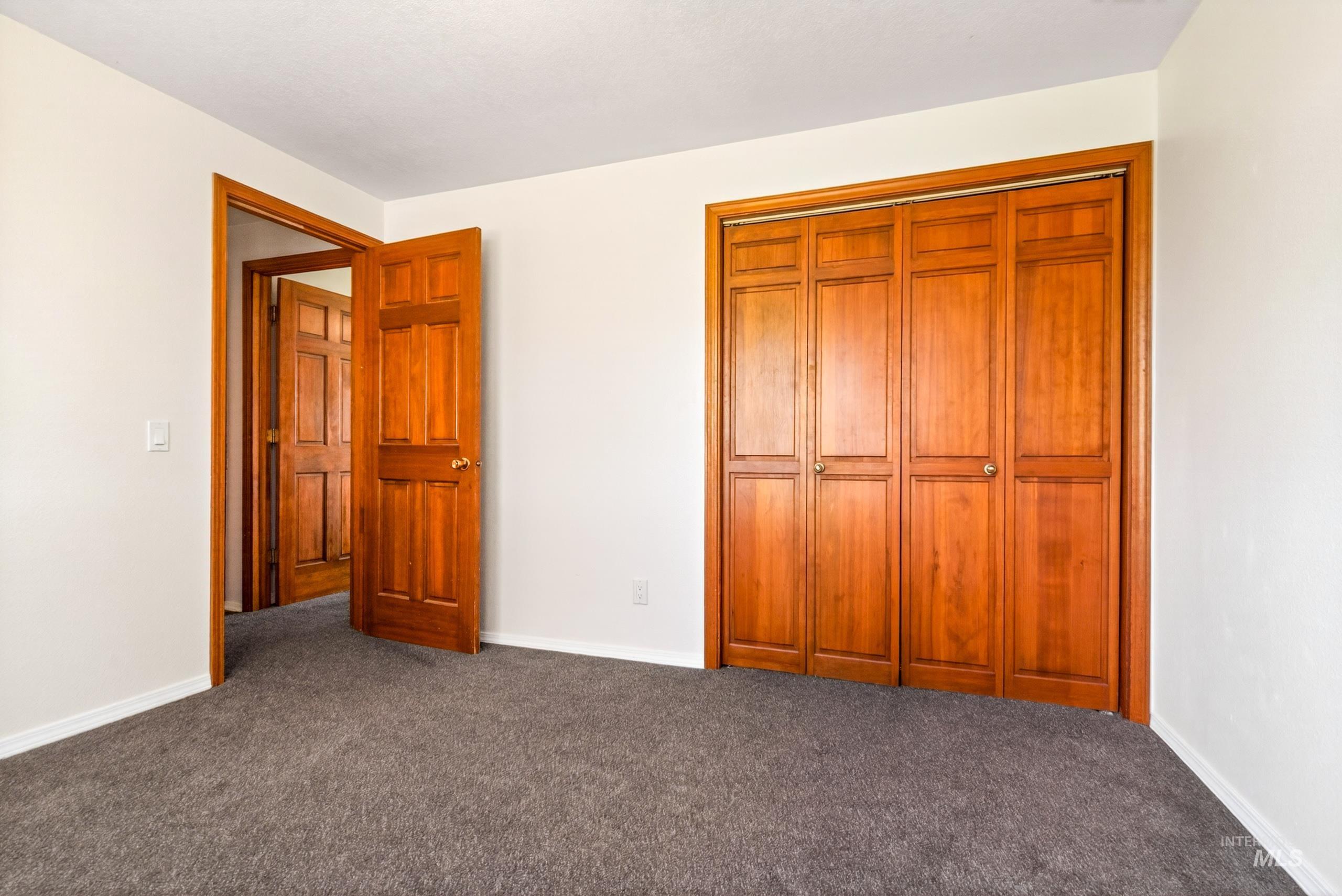 8989 Hillview Road Emmett, ID 83617 - Photo 28 of 50 Unfurnished bedroom with a closet and dark colored carpet