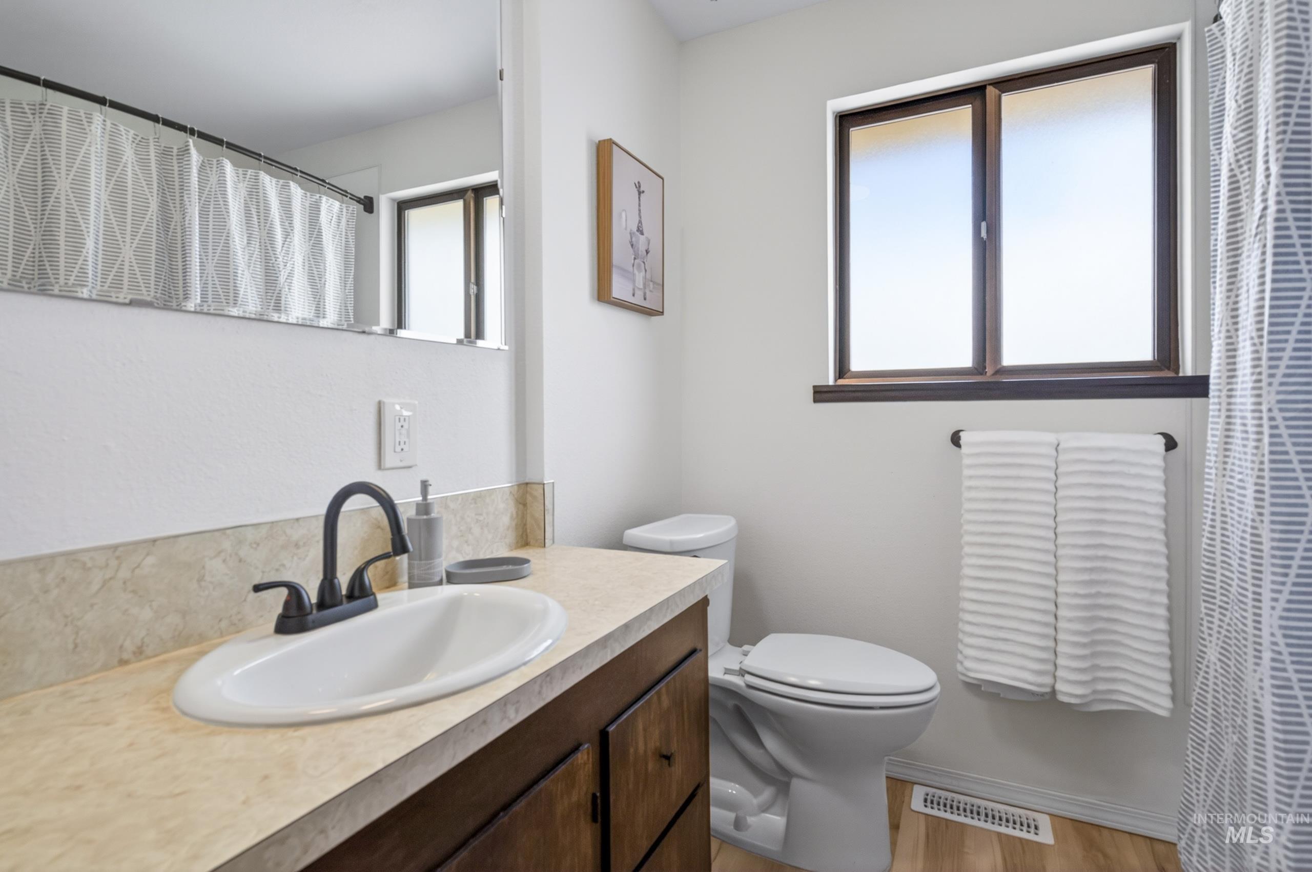 8989 Hillview Road Emmett, ID 83617 - Photo 29 of 50 Full bathroom with vanity, a shower with curtain, and light wood-style flooring