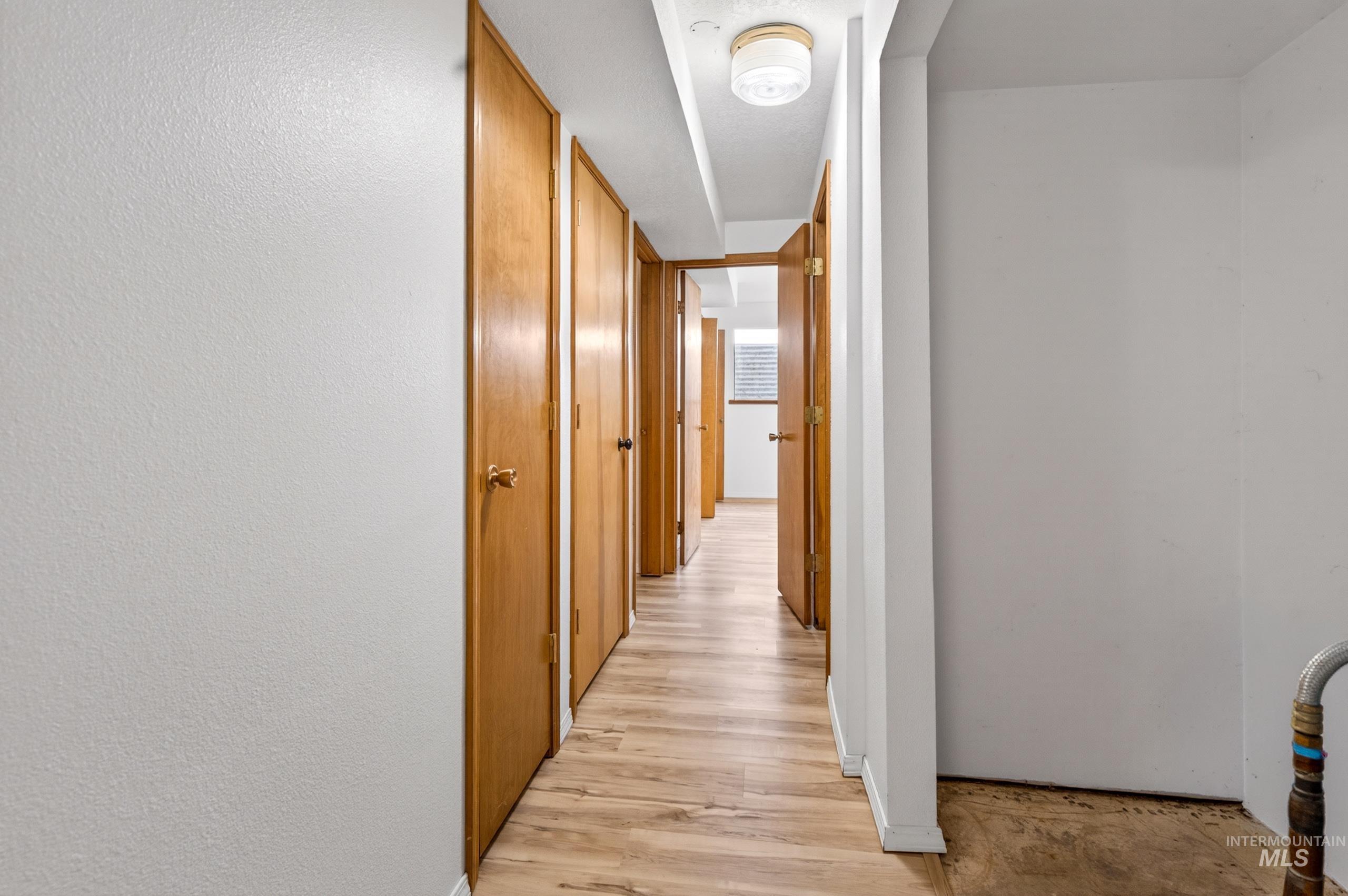 8989 Hillview Road Emmett, ID 83617 - Photo 40 of 50 Hall with light wood-type flooring and a textured wall