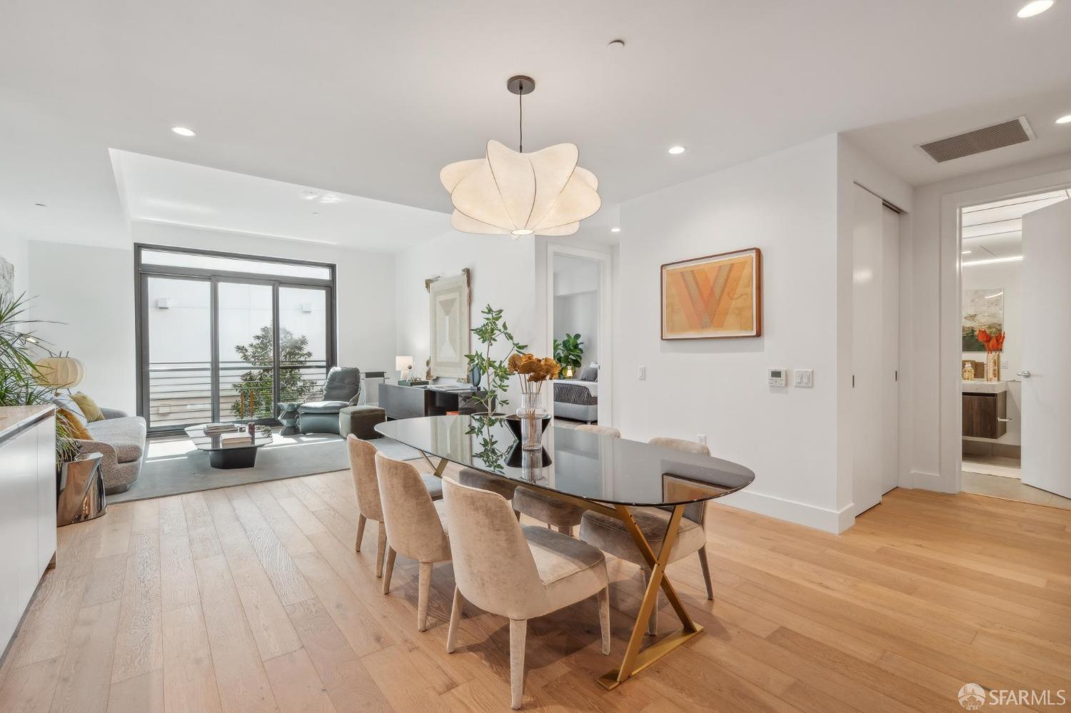 a view of a dining room with furniture wooden floor and chandelier