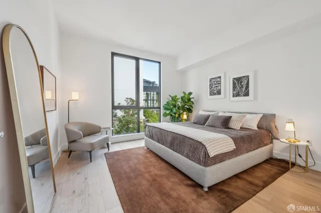 a spacious bedroom with a large bed and a couch