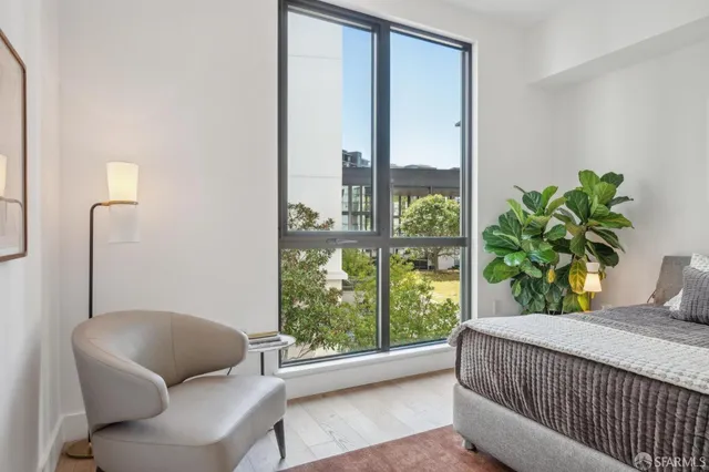 a bedroom with a balcony a bed and a couch