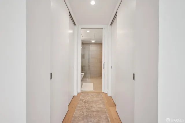 a view of a hallway with wooden floor
