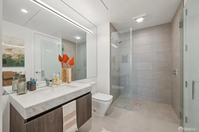 a bathroom with a sink a toilet and shower