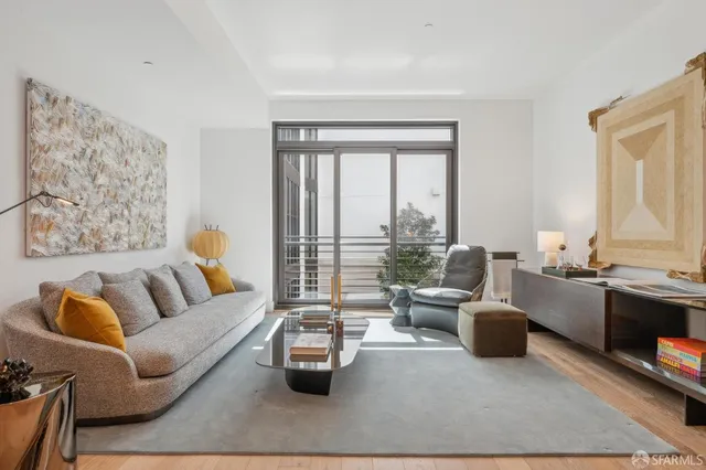 a living room with furniture fireplace and a large window