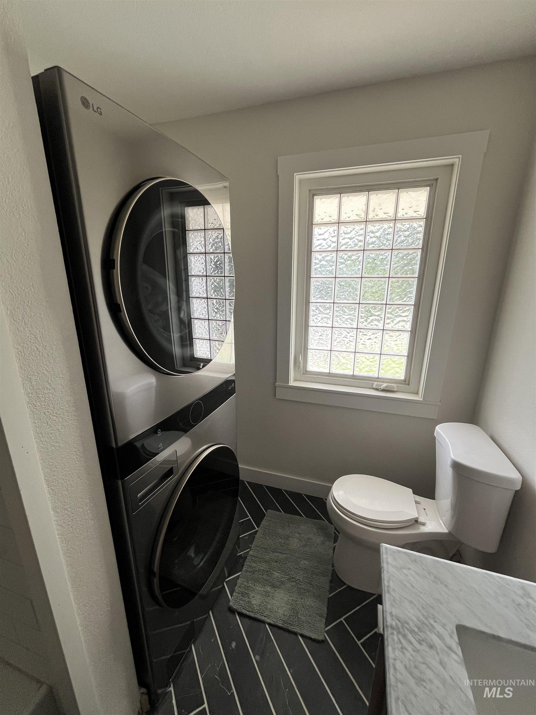 1024 El Cajon Street Moscow, ID 83843 - Photo 15 of 49 Bathroom featuring stacked washer / dryer and vanity