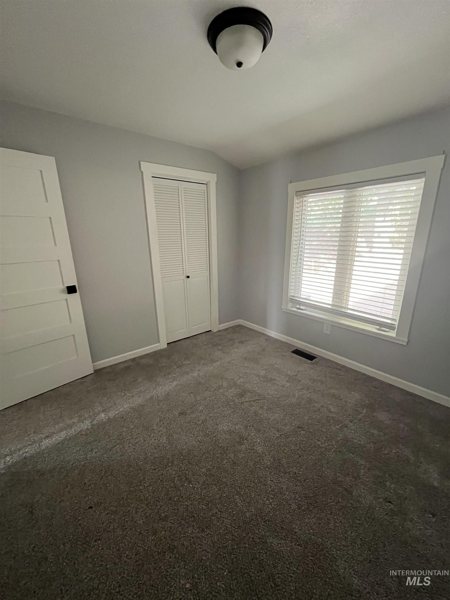 1024 El Cajon Street Moscow, ID 83843 - Photo 19 of 49 Unfurnished bedroom featuring dark colored carpet and a closet