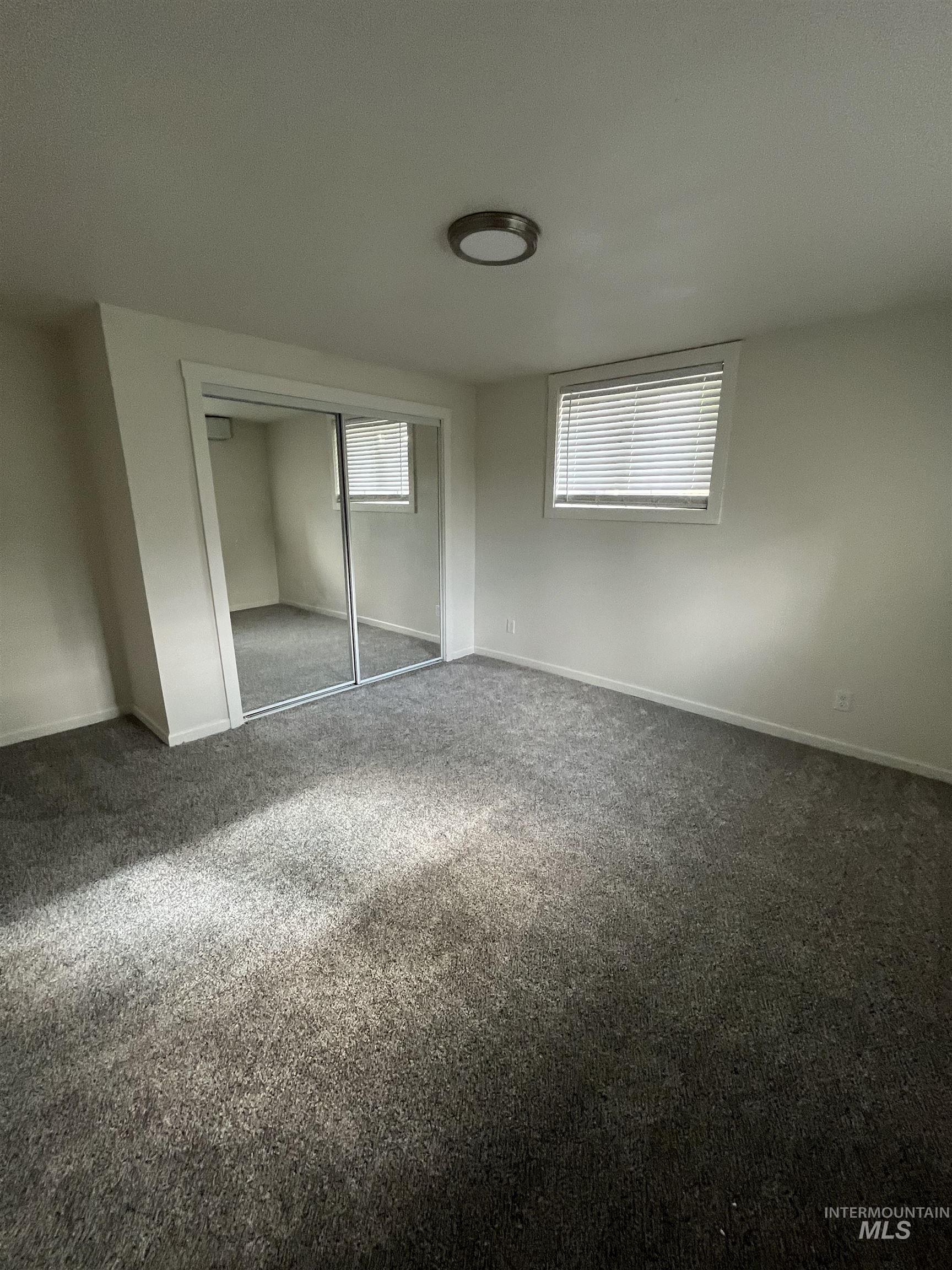 1024 El Cajon Street Moscow, ID 83843 - Photo 35 of 49 Unfurnished bedroom with multiple windows, carpet, and a closet