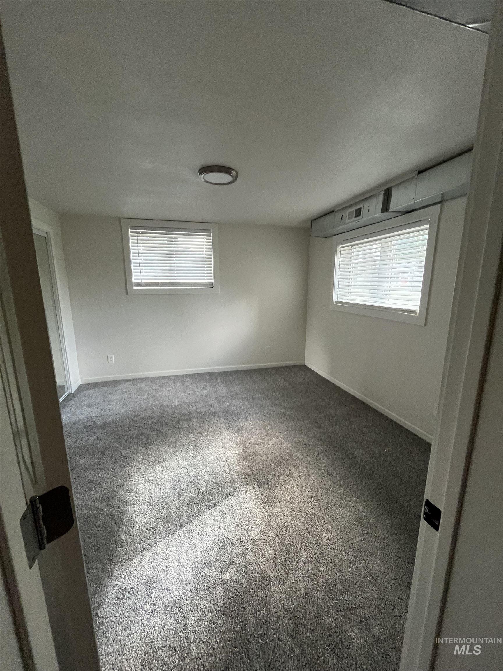 1024 El Cajon Street Moscow, ID 83843 - Photo 36 of 49 Carpeted empty room featuring baseboards and a textured ceiling