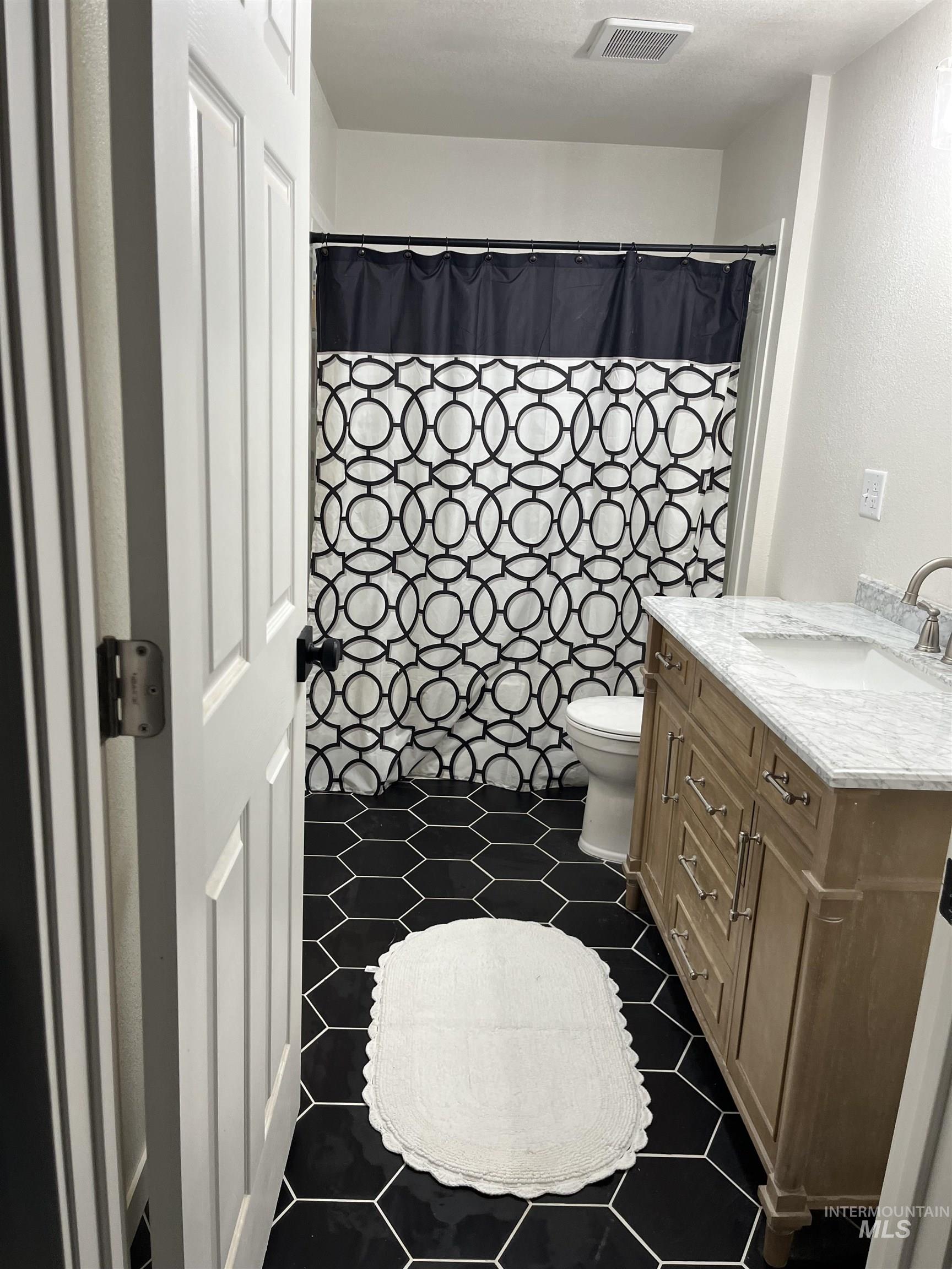 1024 El Cajon Street Moscow, ID 83843 - Photo 37 of 49 Full bath with vanity and tile patterned flooring