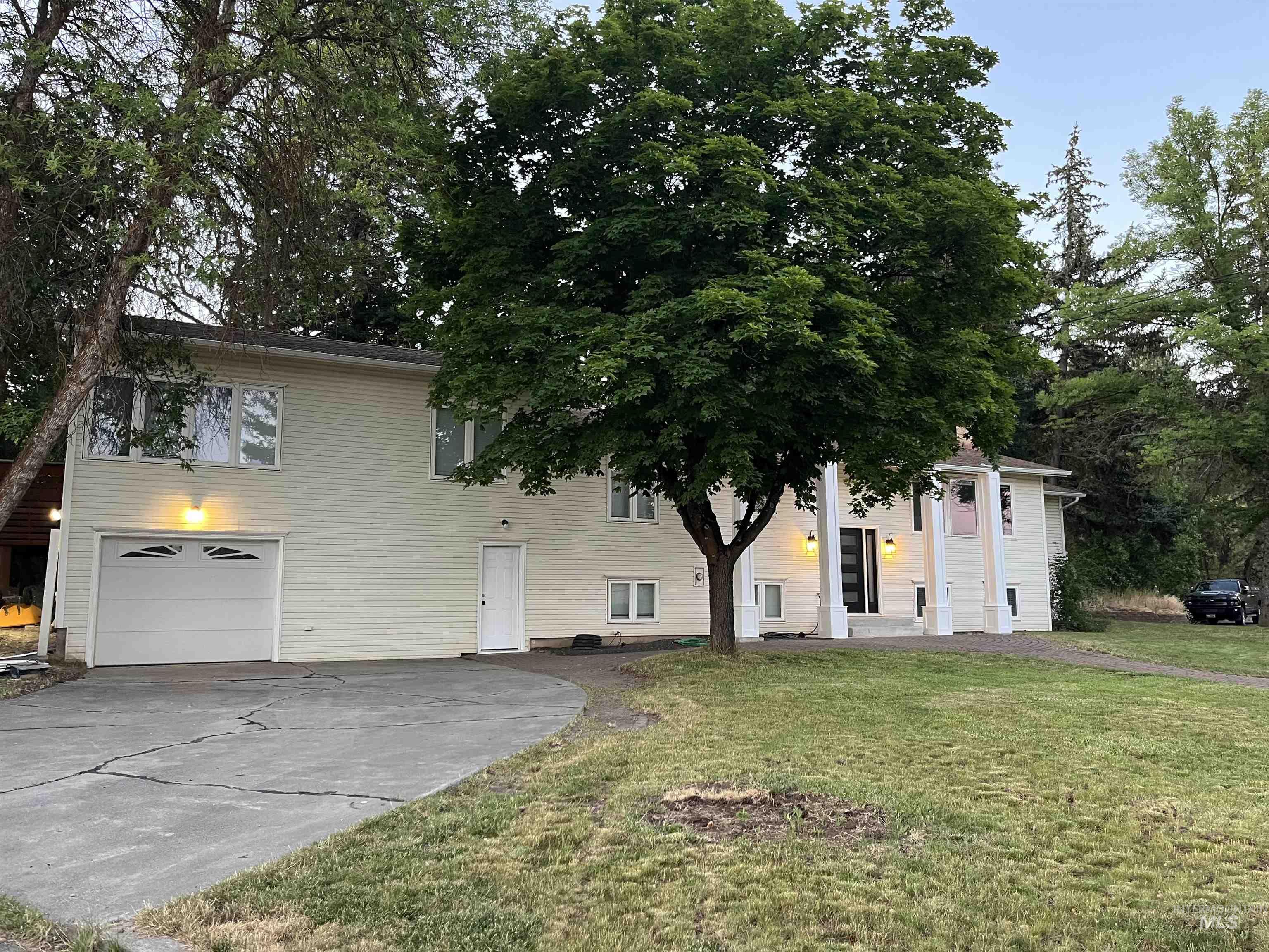 1024 El Cajon Street Moscow, ID 83843 - Photo 4 of 49 View of front of home with concrete driveway, a front yard, and a garage