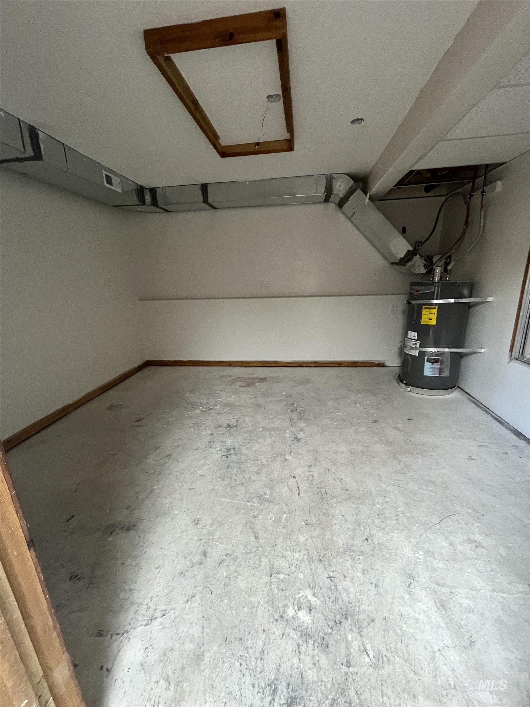 1024 El Cajon Street Moscow, ID 83843 - Photo 44 of 49 Garage featuring water heater and baseboards
