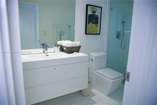 a bathroom with a sink toilet and mirror