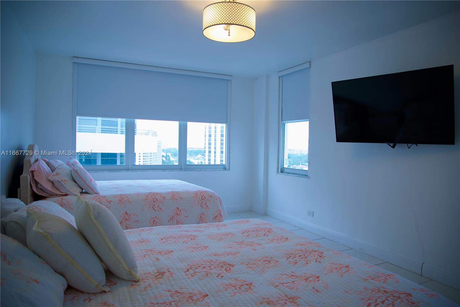 5601 Collins Avenue, Unit 1614 Miami Beach, FL 33140 - Photo 12 of 19 a living room with furniture and a flat screen tv