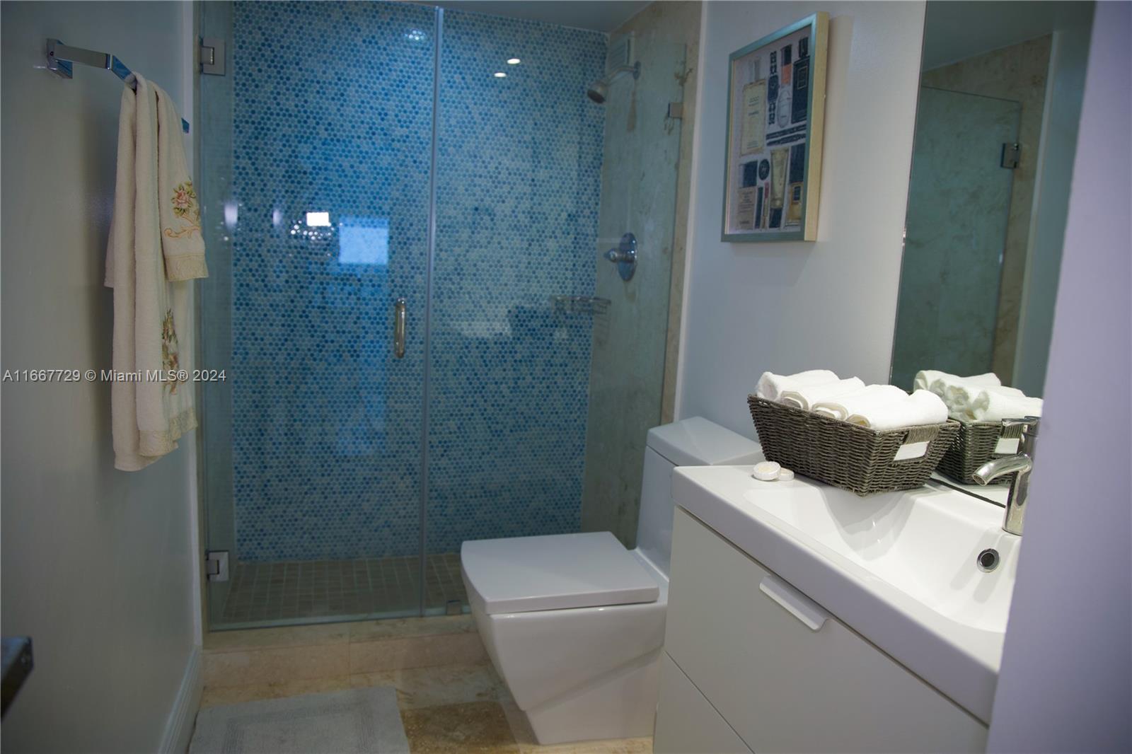5601 Collins Avenue, Unit 1614 Miami Beach, FL 33140 - Photo 14 of 19 a bathroom with a sink toilet and shower