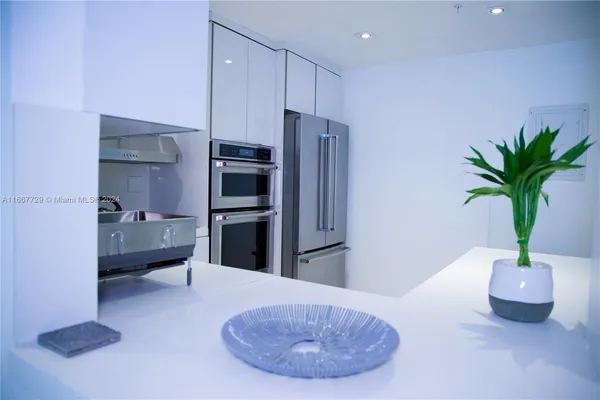 a kitchen with stainless steel appliances a refrigerator and a sink