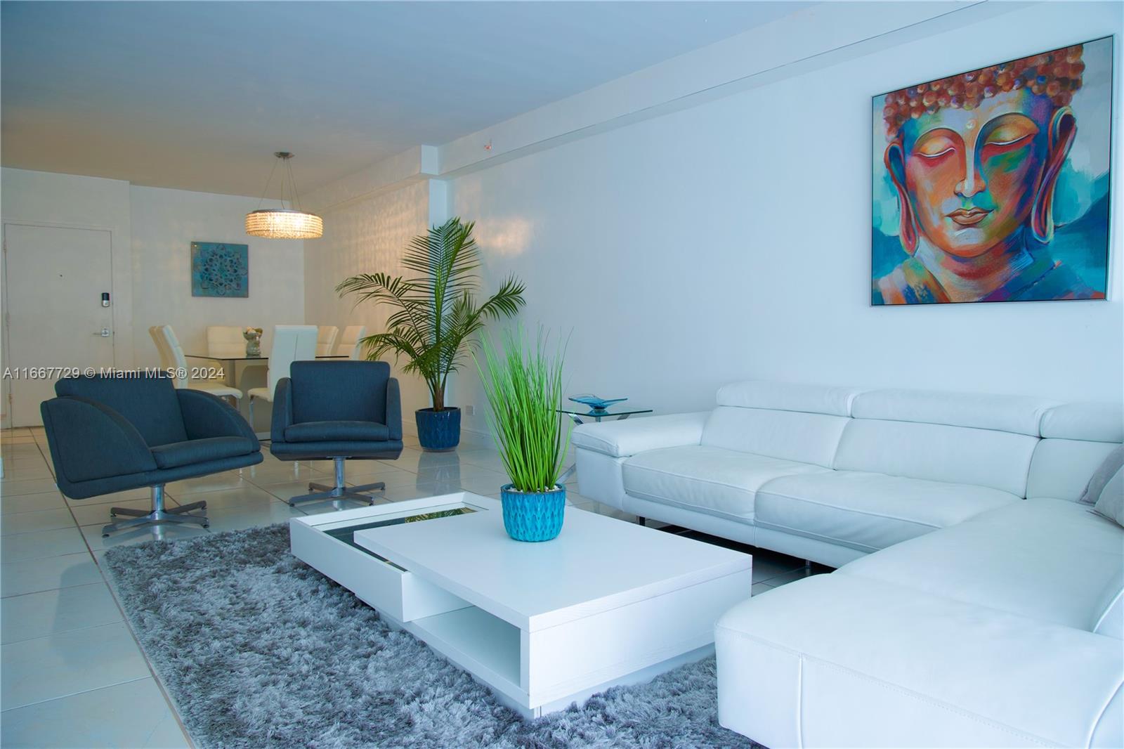 5601 Collins Avenue, Unit 1614 Miami Beach, FL 33140 - Photo 10 of 19 a living room with furniture and a potted plant