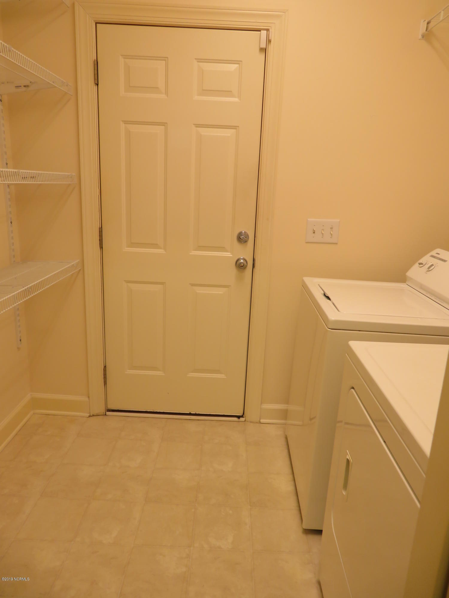1306 Arbor Ridge Way Leland, NC 28451 - Photo 15 of 21 Laundry has many shelves and accesses the garage
