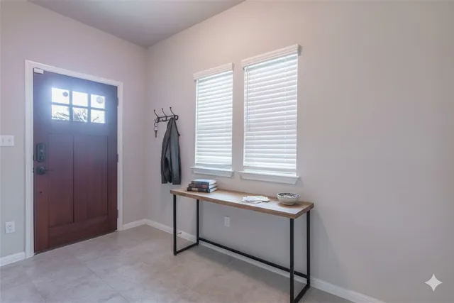 a room with a table and windows