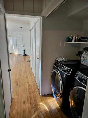 a view of a storage and utility room with washer and dryer