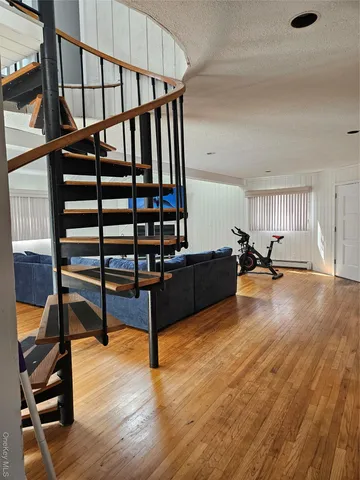 a view of entryway and hall with wooden floor