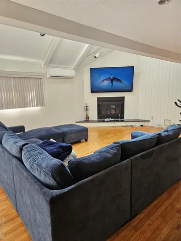 a living room with furniture pool kitchen view and a fireplace