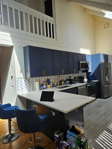 a kitchen with a table chairs stove and refrigerator