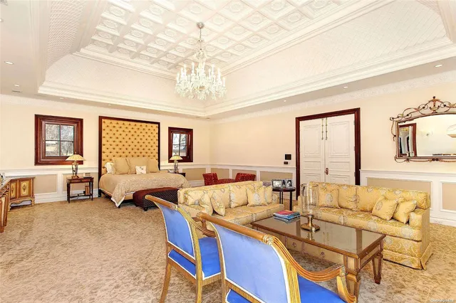 a living room with furniture and a chandelier