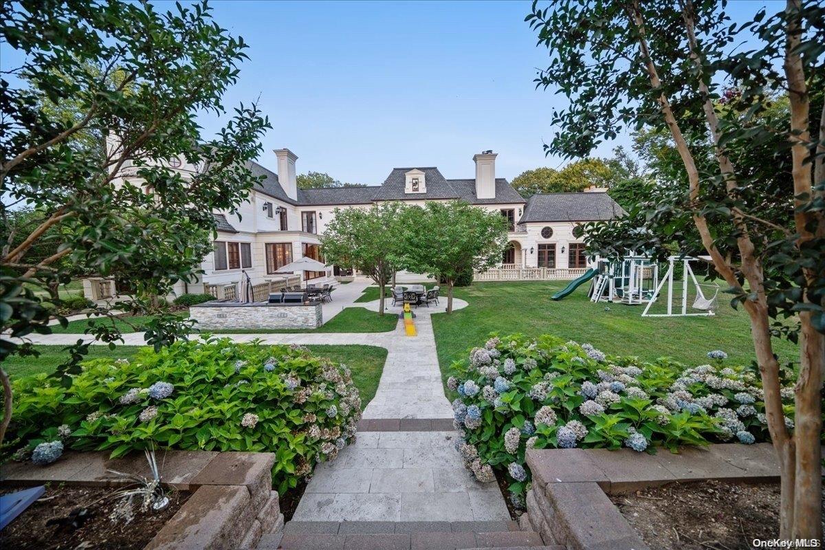 5 Longwood Road Sands Point, NY 11050 - Photo 22 of 27 a view of house with garden space and trees
