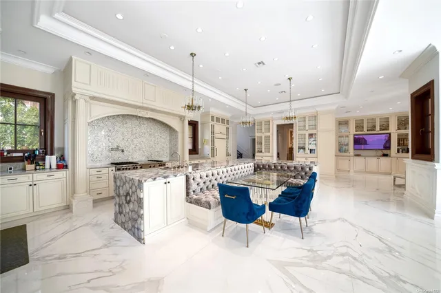 a large kitchen with a table and chairs