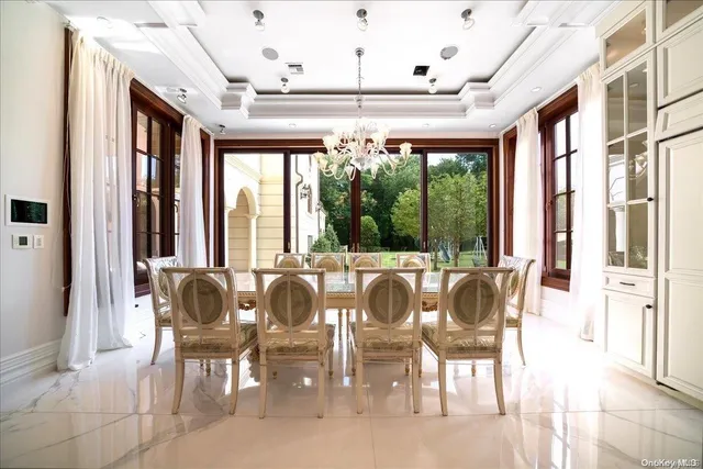 a view of a dining room with furniture large windows and wooden floor