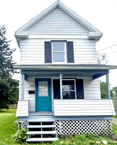 a front view of a house with a garden
