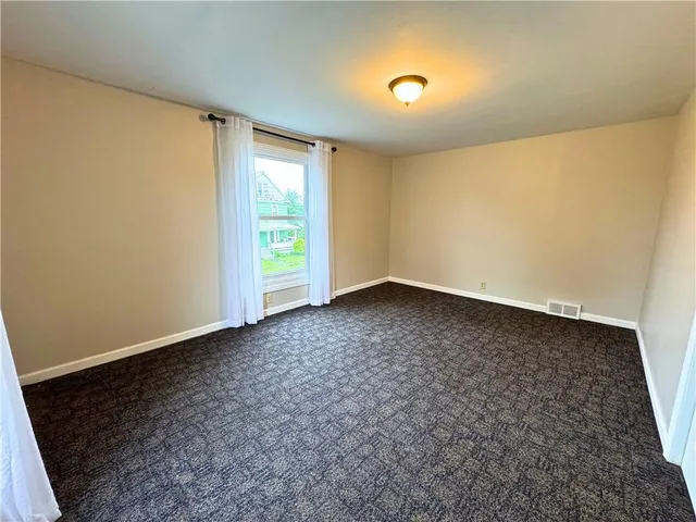 an empty room with a empty space and a window