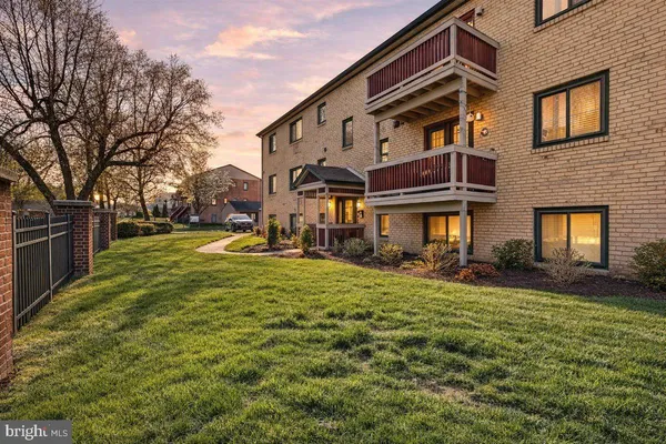 a view of a big house with a yard