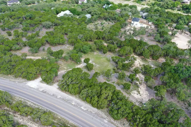 a view of a field of grass and trees