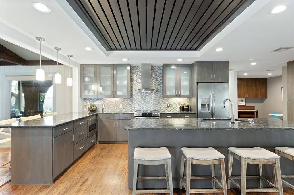 a large kitchen with lots of counter space and stainless steel appliances